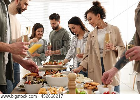 Group Of People Enjoying Brunch Buffet Together Indoors