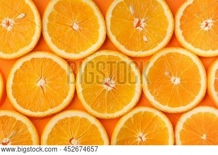 Background Of Fresh Juicy Orange Slices With Pits