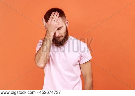 Portrait Of Bearded Man Holding Big Clock And Biting Nails, Nervous About Delayed Meeting Or Deadlin
