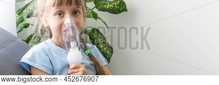Little Girl Making Inhalation With Nebulizer At Home. Child Asthma Inhaler Inhalation Nebulizer Stea