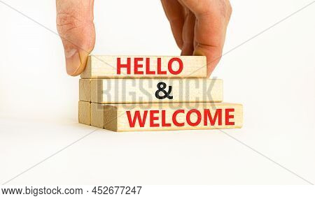 Hello And Welcome Symbol. Concept Words Hello And Welcome On Wooden Blocks. Businessman Hand. Beauti