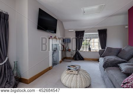 Fen Drayton, England - June 7 2018: Furnished Sitting Room Snug With Televison And Cast Iron Firepla