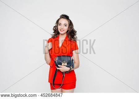 Smilling Girl With Fashionable Bag Over White Background.