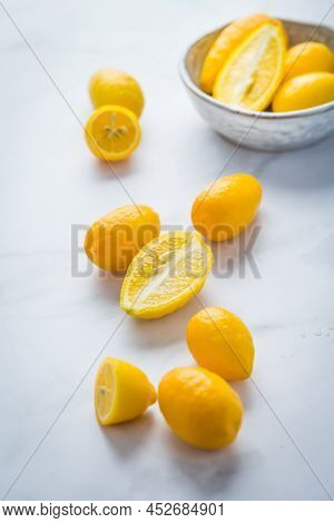 Small citrus fruits limequat with bowl on table