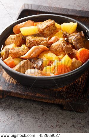 Pork Menudo Is A Filipino Pork Stew Dish With Carrots And Potato Close Up In The Plate On The Table.