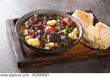 Stone Soup Of Red Beans, Potatoes, Chorizo, Black Pudding Close-up In A Bowl On A Wooden Tray. Horiz