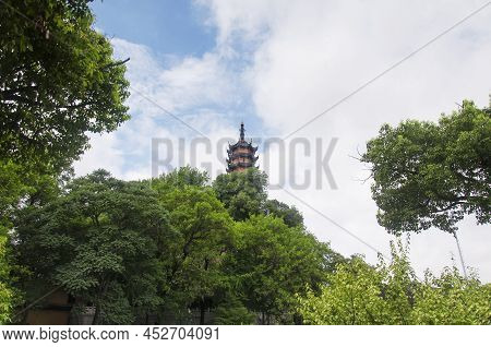 Cishou Pagoda Rising Above The Trees Within The Jinshan Buddhist Temple Scenic Area In Zhenjiang Chi