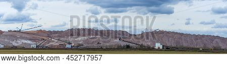 Giant Spreader Or Absetzer Machinery. A Large Dumper On A Landfill With Potash Ore. Extracting And M
