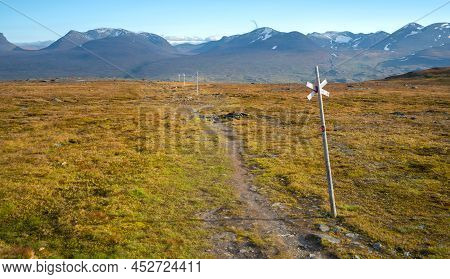 Wooden Markers On Nuolja, Or Njulla Mountain, In Abisko National Park In Arctic Sweden. Adventure In