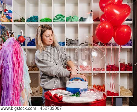 Woman Aerodesigner Stretches Air Clear Balloon Before Inflating It Helium.
