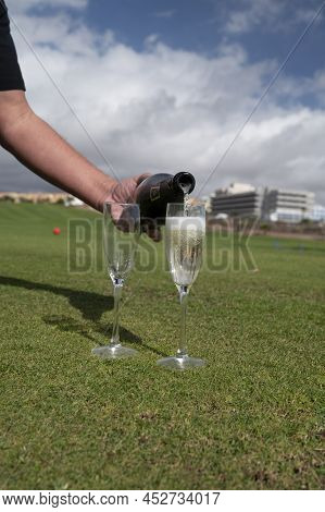 Celebration Of Championship With Glasses Of Champagne Bubbles Wine On Green Lawn Of Golf Club
