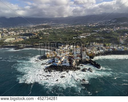 Aerial View On Colorful Houses And Black Lava Rocks In Small Village Punta Brava Near Puerto De La C