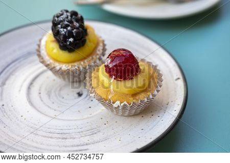 Mini Fruit Italian Cupcakes With Fresh Berries On Board