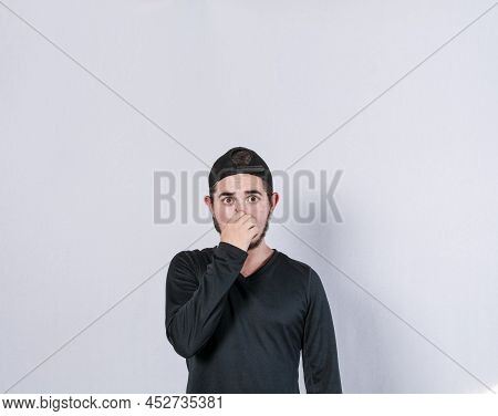 Close Up Of A Man Covering His Nose, A Guy With A Face Of Unpleasant Odors, Latino Man Covering His