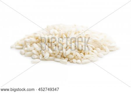 Uncooked Carnaroli risotto rice isolated on a white background.