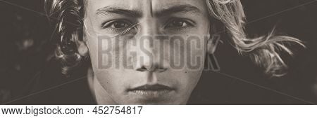 Young Boy Model Black And White Portrait In Banner Header Size. Serious Face Of Teenager