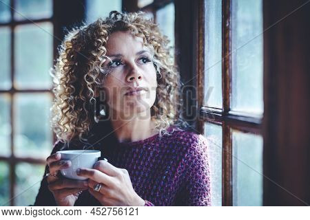 Portrait Of Attractive Thoughtful Adult Woman At Home