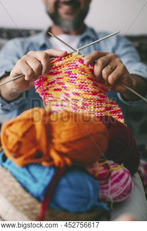 Close Up Of Adult Man Working With Ball Yarn Of Colorful Wool. Happy People In Indor Hobbies Activit