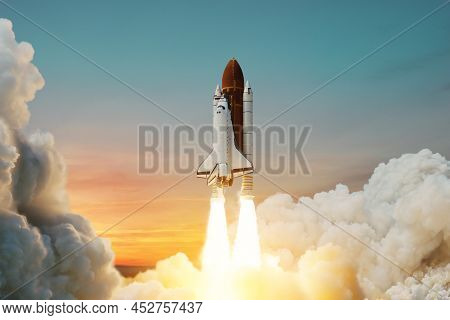 Spaceship Lift Off. Space Shuttle With Smoke And Blast Takes Off Into Space On A Background Of Sunse