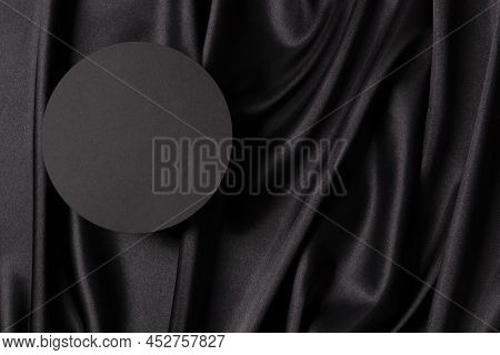 Empty Round Platform Podium On Beautiful Black Color Background With Drapery And Wavy Folds Of Silk 