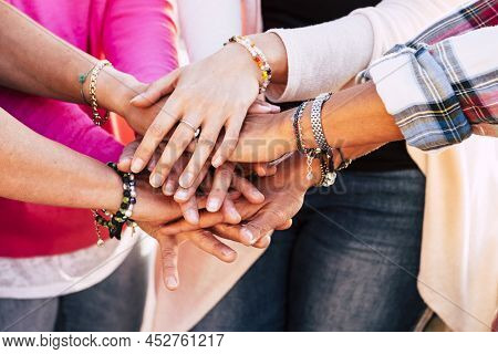 Close Up Of Young People Putting Their Hands Together. Friends With Stack Of Hands Showing Unity And