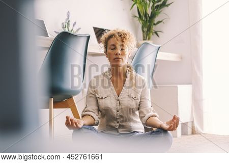 Woman Do Loto Position At Home To Relax And Wellbeing. Indoor Relaxed Activiy For Adult Female Peopl