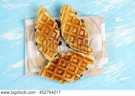 Croffle With Chocolate. A Popular Dish Is A Hybrid Of Croissant And Waffle. Blue Background