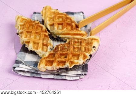 Croffle Or Croisant Waffle Dessert, A Marriage Between A Croissant And A Waffle Iron. Pink Backgroun