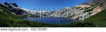 Alpine blue lake panorama, Laguna Azul in Nahuel Huapi National Park, granite walls of Cerro de las Cristales mountain, Argentina, Nature of Patagonia