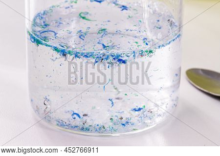 Becker Cup With Polluted Water, Contaminated With Traces Of Plastic And Micro Plastic, Polymer Parti