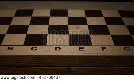 Shabby Folding Wooden Chessboard. Playing Chess With Wooden Lacquered Pieces. Black And White Square