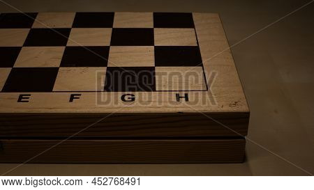 Shabby Folding Wooden Chessboard. Playing Chess With Wooden Lacquered Pieces. Black And White Square