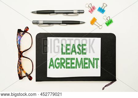 Text Sign Showing Lease Agreement. Word For Contract On The Terms To One Party Agrees Rent Property 