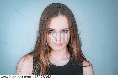 Fashion Portrait Of A Beautiful Young Woman Posing Over White Background. Close Up Portrait Of A Bea