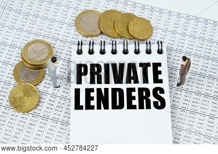 Business And Finance Concept. On Financial Reports There Are Figurines Of People, Coins And A Notepa