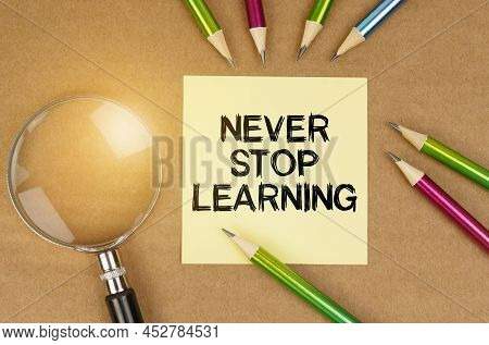 Education Concept. On The Table Are Pencils, A Magnifying Glass And A Sticker With The Inscription -