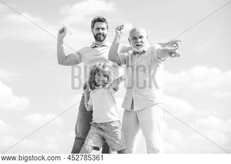 Active Family Leisure With Kids. Boy Son With Father And Grandfather With A Toy Airplane Plays On Su