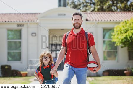American Father And Son Walking Trough School Park. Parent Take Child To School. Pupil Of Primary Sc