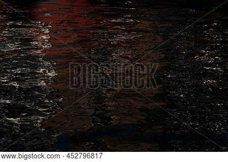 Multicolored Reflections On The Water Surface In The Evening. Art Of Nature. Abstract Backdrop.