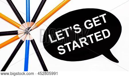 On A Light Background, Multi-colored Pencils And On A Black Background A White Card With The Text Le