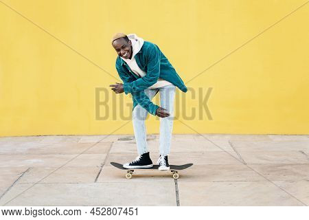 Funny Black Man Enjoying Riding A Skateboard. Concept Of Happiness And Satisfaction