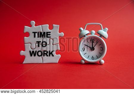 Time To Work Text On Jigsaw Puzzle With Alarm Clock Pointing At 10 O'clock. Business Concept