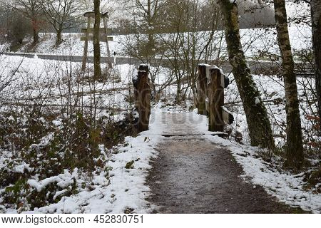 Way Across A Slippery Wooden Bridge With Muddy Snow