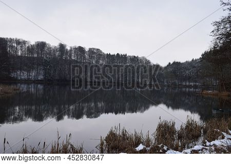 Gloomy And Calm Looking Caldera Lake Holzmaar On A Dark Winter Day