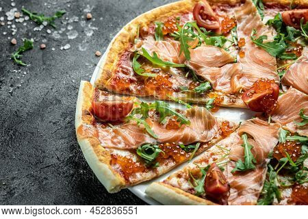 Delicious Hot Pizza With Salmon, Red Caviar, Tomatoes And Aragula Ready To Eat. Banner, Menu, Recipe