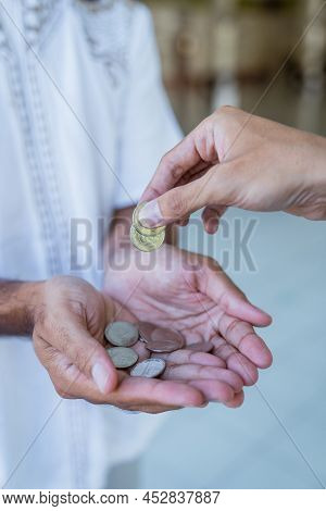 Hand Giving Some Money To Someone At The Mosque