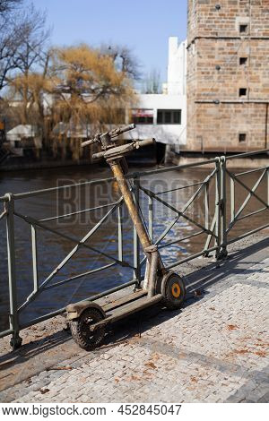 Two Drowned Electric Rent Scooters In The Mud Stand On The Citys Embankment. Vandals Throw Scooters 