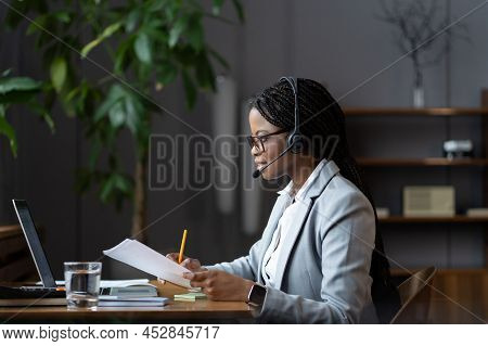 Concentrated Young African Woman Remote Customer Service Representative Specialist In Wireless Heads