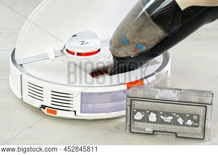 Tallinn, Estonia - March 03, 2022: Xiomi S7 Robot Vacuum Cleaner Cleaning With Other Hoover. The Fil