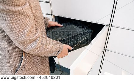 Pickup Parcel. Courier Box In Woman Hands At Post Delivery Automat Terminal. Self Service Post Termi